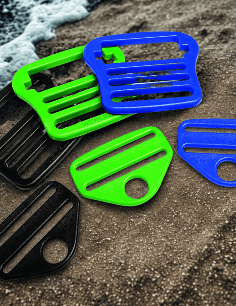 Colorful plastic clips or buckles on a textured surface.
