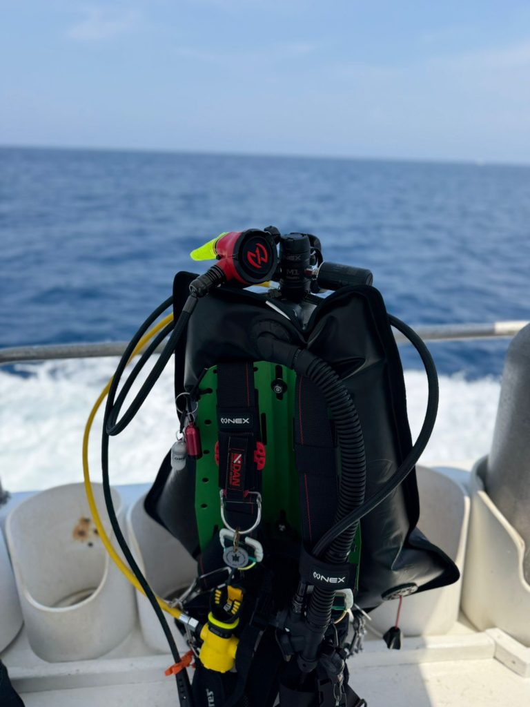 Scuba diving gear on a boat deck.